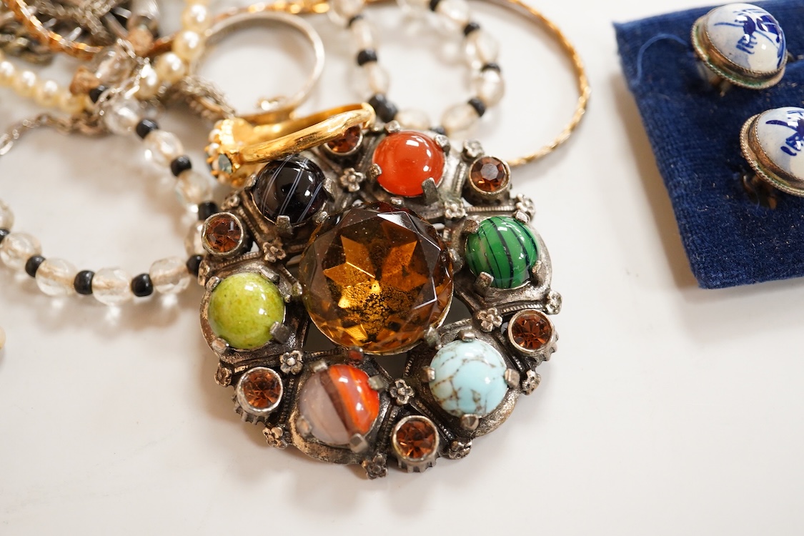 A collection of silver and costume jewellery, including a silver locket, St Christopher ingot pendant and watch chain, and a selection of costume jewels